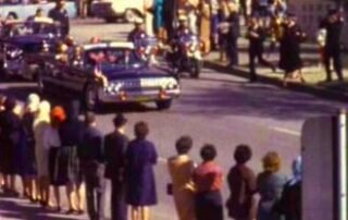 President John F. Kennedy's motorcade traveling through Dealey Plaza in Dallas, Texas, on November 22, 1963.
